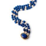 A LAPIS LAZULI AND PEARL NECKLACE Bezel-set to the centre with an oval cabochon lapis lazuli, 30mm