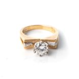 A DIAMOND RING Claw-set to the centre with a round brilliant-cut diamond weighing approximately 0,