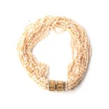 A MULTI STRAND OF FRESHWATER PEARLS 14 strands interwoven with an 9ct yellow gold barrel-style