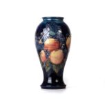A ‘BLUE FINCH WITH FRUIT’ PATTERN VASE BY SALLY TUFFIN FOR MOORCROFT The elongated baluster form