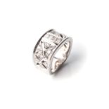 A DIAMOND DRESS RING Channel-set to the centre with a row of princess-cut diamonds and butterfly-set