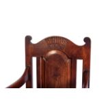 A PAIR OF WAINSCOT ARMCHAIRS With carved wooden backs, arm supports, front legs shaped on a lathe,