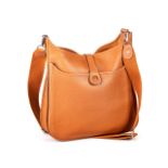 A HERMES "LE CUIR" Brown leather monogrammed bag, with shoulder strap, accompanied by dust cover and