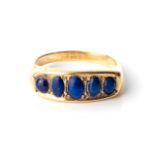 A DIAMOND ETERNITY RING Claw-set, 5 round lapis lazuli in an 18ct gold ring, size L