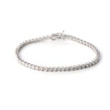 A DIAMOND TENNIS BRACELET Claw-set with round, brilliant-cut diamonds, weighing approximately 6,