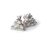 A PAIR OF TRILOGY DIAMOND EARRINGS Claw-set with 9 round, brilliant-cut diamonds, weighing 1,