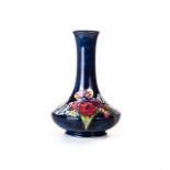 A MOORCROFT 'ORCHID' PATTERN BOTTLE VASE Dark blue ground, painted signature, impressed factory