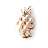 A PEARL BROOCH Designed as a spray, claw-set with a combination of11 freshwater cultured pearls in