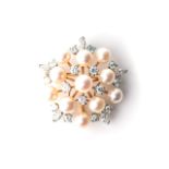 A PEARL BROOCH Designed as a spray, claw-set with a combination of 11 freshwater cultured pearls,