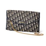 A CHRISTIAN DIOR CLUTCH Monogrammed brown and gold fabric vintage, fold-over top, rolled gold