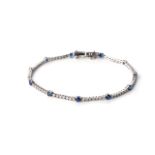 A SAPPHIRE AND DIAMOND TENNIS BRACELET Claw-set with 73 round brilliant-cut diamonds weighing 1,