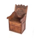 AN OAK BOX SEAT ARMCHAIR, LATE 17TH/EARLY 18TH CENTURY With a carved back, upright panel, seat