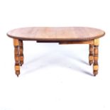 A LATE VICTORIAN OAK WIND OUT TABLE With oval top, moulded edge, two removable leaves, wind out