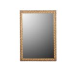 A GILTWOOD MIRROR, 20TH CENTURY A foliage decorated frame, mirror plate with beveled glass, 113cm