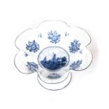 A DELFT FRUIT BOWL Pierced, reticulated, scalloped rim, painted to the centre with sailing ships,