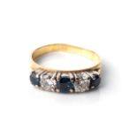A DIAMOND ETERNITY RING Claw-set 3 round brilliant-cut sapphires with a combined weight of