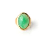 A JADE RING Bezel-set to the centre with an oval cabochon jade, in an 18ct yellow gold signet-