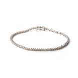 A DIAMOND TENNIS BRACELET Claw-set with round, brilliant-cut diamonds, weighing approximately 2,