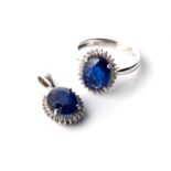 A SAPPHIRE RING WITH MATCHING PENDANT The ring claw-set to the centre with an oval-cut, natural