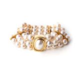 A PEARL BRACELET Bezel-set to the centre with an oval mabé pearl in an 18ct yellow gold