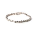 A DIAMOND TENNIS BRACELET Claw-set with 40 round, brilliant-cut diamonds, weighing approximately