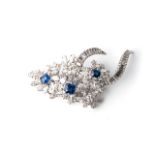 A DIAMOND AND SAPPHIRE BROOCH Claw-set to the centre and sides with 3 emerald-cut sapphires with a