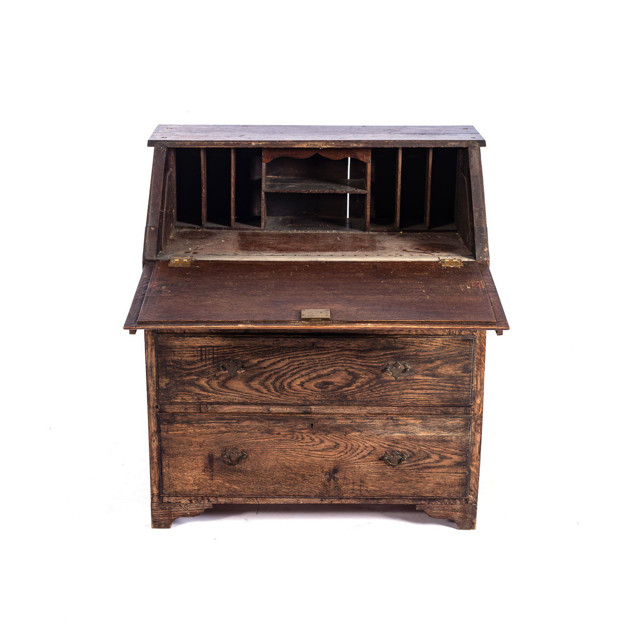 AN OAK BUREAU, 19TH CENTURY With a carved fall front, revealing a fitted interior supported by