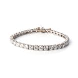 A DIAMOND TENNIS BRACELET Claw-set with 38 round brilliant-cut diamonds weighing approximately 11,