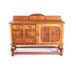 A VICTORIAN OAK SIDEBOARD With a rectangular top, back panel, above blind door and graduating