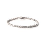 A DIAMOND TENNIS BRACELET Claw-set with round, brilliant-cut diamonds, weighing approximately 3,