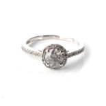 A DIAMOND HALO RING Claw-set to the centre with a round, brilliant-cut diamond, weighing 1,01cts,