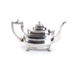 A GEORGE III SILVER TEA POT, LONDON, 1810 Stepped rim, hinged cover, raised on four lion and mask