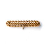 A GOLD BROOCH Woven plated-link design, 7cm long, 18ct yellow gold