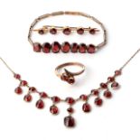 A SUITE OF GARNET JEWELLERY Comprising a necklace, bracelet, ring and a brooch, bezel- and cut-set
