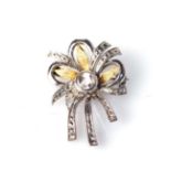 A DIAMOND BROOCH Bezel-set to the centre with an old-cut diamond weighing approximately 0,50ct,