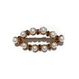 A PEARL AND CITRINE BROOCH the oval shape frame set as an articulated row of pearls interspaced by