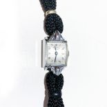 A LADY'S UNIVERSAL GENEVE WRISTWATCH, CIRCA 1950 manual, the 13mm square stainless steel watch