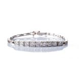 A DIAMOND BRACELET Designed as a 16,5cm articulated line of nine pavé-set round brilliant-cut