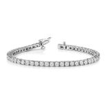 A DIAMOND TENNIS BRACELET claw set with 48 round brilliant cut diamonds weighing approximately 7.5