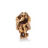 A JAPANESE IVORY NETSUKE OF A SENNIN, TAISHO PERIOD, 1912 - 1926 NOT SUITABLE FOR EXPORTStanding
