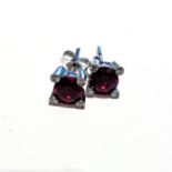 A PAIR OF GARNET STUDS claw set to the centre with two round brilliant cut garnets weighing