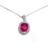 A RUBY AND DIAMOND PENDANT claw set to the centre with an oval brilliant cut ruby weighing