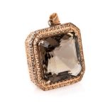 A SMOKEY QUARTZ PENDANT Weighing approximately 100ct, in 14ct gold