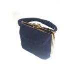 A RUCHED HANDBAG 1960S Navy blue with linear detail, 21cm high, 18cm wide, brass border, 3 inner