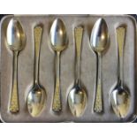 A SET OF SILVER TEA SPOONS with yellow enamel pattern in original box