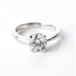 A DIAMOND SOLITAIRE RING Claw set to the centre with a round brilliant-cut diamond weighing