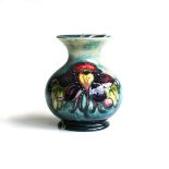 A WILLIAM MOORCROFT 'HIBISCUS' PATTERN VASE On blue ground, centred with a hibiscus flower,