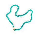 A STRAND OF GREEN BEADS- POSIIBLY JADE 42cm in length, each pearly approximately 4.5mm round, with