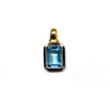 AN AQUAMARINE PENDANT The two-tone pendent bezel set with an emerald-cut aquamarine, in 18K gold