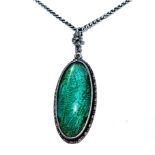 A SILVER PENDANT bezel set to the centre with an oval Morpho butterfly wing, fine wire detail on a